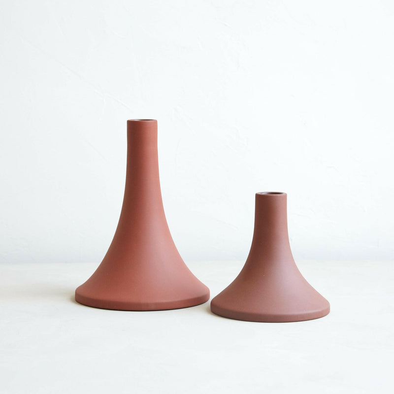 The Floral Society's Grand Tall Earth ceramic taper holder features a clean, matte finish, fitting standard candles, with a unique hand-finished design.