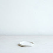 The Floral Society | Daily Plate, Sand: A minimalist white ceramic dish, ideal for holding candles or as a versatile accessory for any kitchen or dining space.