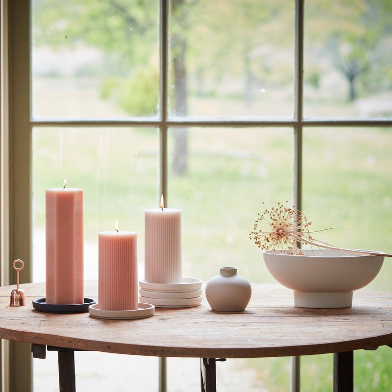 The Floral Society | Daily Plate, Sand displays three ribbed pillar candles and a bud vase on a wooden table, epitomizing minimalist elegance and functionality.