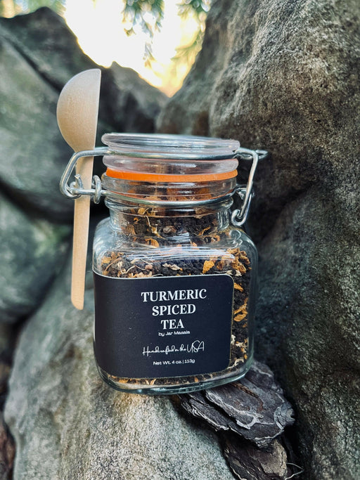 Jar of turmeric spiced tea with a label, showcasing a handcrafted masala blend by a women-owned company, ideal for a rich sensory experience.