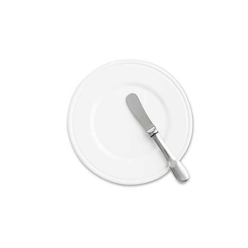 Close-up of a knife from the Match Convivio Dinner Collection on a bread plate, showcasing sleek lines and polished finish for elegant dining.