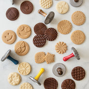 Nordic Ware | Citrus Cookie Stamps featuring various cookie shapes, including citrus slices and wreaths, with round metal stamps and wooden handles, ideal for lemon or Key Lime cookies.