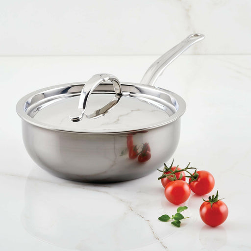 Hestan NanoBond | Cookware - 5qt Essential Pan + Lid on marble countertop, accompanied by vine-ripened cherry tomatoes and fresh herb, showcasing premium, durable stainless-steel design.