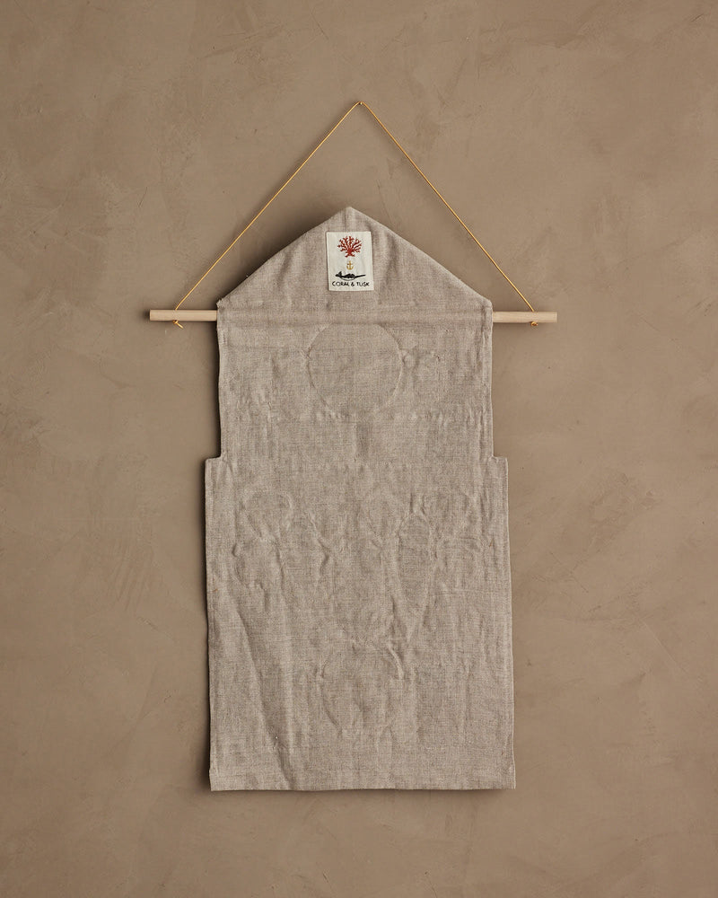 Coral & Tusk | Christmas Clock Advent Calendar features a linen wall pouch with a red coral patch, designed for festive organization with 25 hidden pockets.