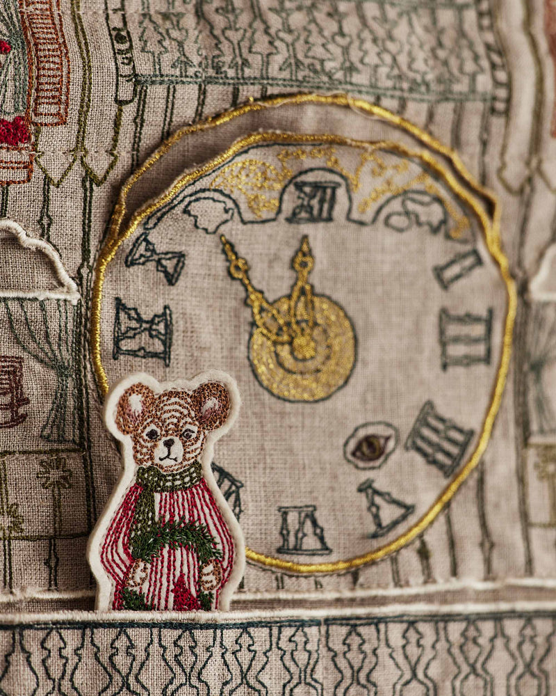 Coral & Tusk | Christmas Clock Advent Calendar featuring a bear with wreath, gold clock face, and intricate embroidery, perfect for holiday countdowns.
