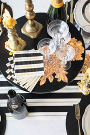 Hester & Cook's Gold Celebration Collection Black & Gold Awning Stripe Cocktail Napkins feature elegant foil accents, perfect for elevating any festive gathering.