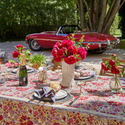 Caravan Home 71 x 106 Red & Grey Tablecloth on a table, adorned with plates and a floral centerpiece, capturing a French garden-inspired aesthetic.