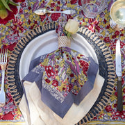 Caravan Home | 71 x 71 Red & Grey Tablecloth featuring vibrant floral patterns, elegantly set with silverware and a glass, embodying French garden-inspired craftsmanship.