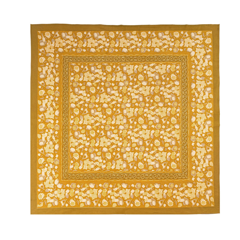 Caravan Home's 71 x 71 Forest Harvest Grey & Mustard Tablecloth showcases a yellow and white floral pattern, enhancing dining experiences with artisan-crafted elegance.