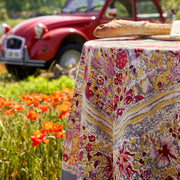 Caravan Home 71 x 106 Red & Grey Tablecloth draped over a table, showcasing a sandwich, in front of a red car, epitomizing Jardin collection's artistic elegance.
