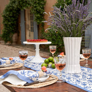 Caravan Home 19 x 19 Granada Cornflower Blue Napkins Set of 6, featuring floral patterns, displayed on a table with a pie and wine glasses.