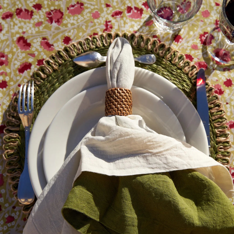 Caravan Home 21 x 21 Ivory Everyday Napkins Set of 4, displayed elegantly on a dining plate, embodying refined craftsmanship and luxurious texture.