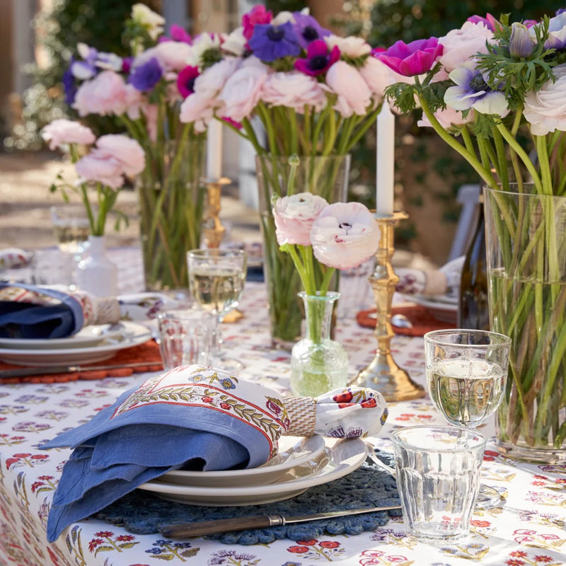 Caravan Home Lake Everyday Napkins Set of 4 displayed on a table with elegant tableware, including plates, glasses, and a floral centerpiece.
