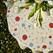 Caravan Home | 59 x 86 Springfields Multi French Tablecloth, featuring handprinted poppies and wildflowers, beautifully displayed on a dining table, evoking countryside charm.