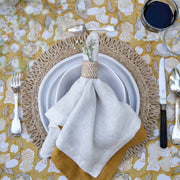 Caravan Home 21 x 21 White Everyday Napkins set of 4 displayed elegantly on a table setting with glasses, showcasing refined craftsmanship and casual luxury.