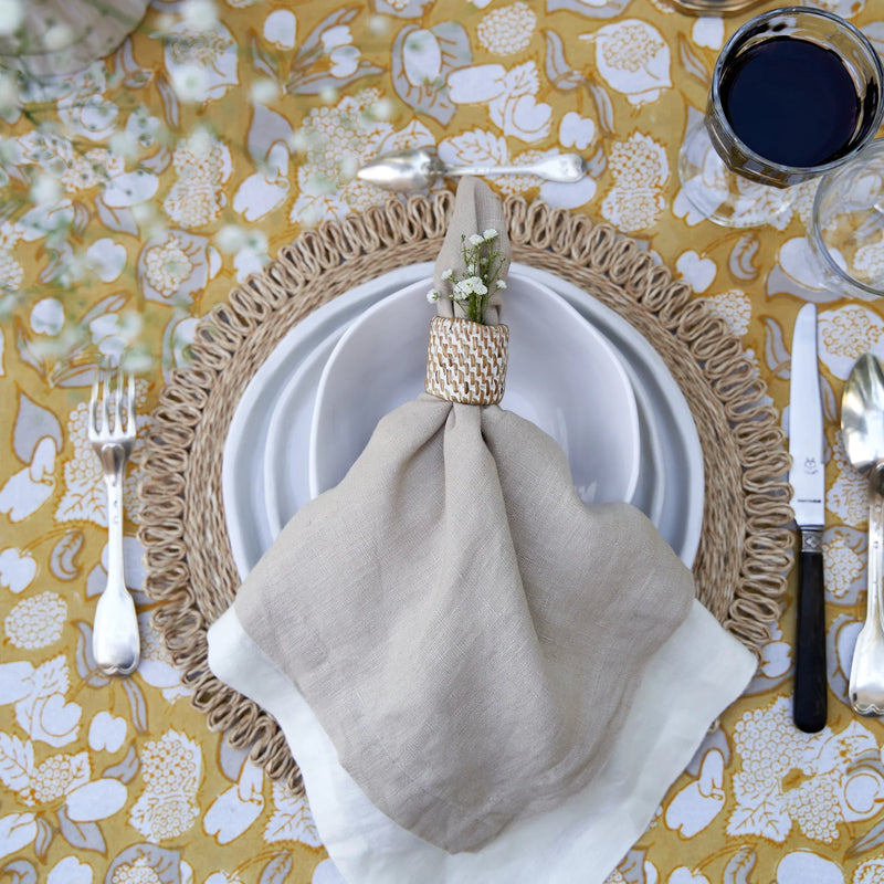 Caravan Home | 21 x 21 Stone Everyday Napkins Set of 4, elegantly folded on a table setting with glassware, enhancing dining sophistication.