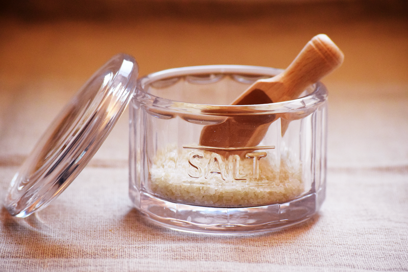 Earth & Nest Salt Pot with Wooden Scoop, a glass container for seasoning, blending elegance and functionality, ideal for enhancing your kitchen experience.