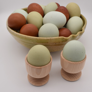 Earth & Nest | Egg Cup: A wooden egg cup ideal for Easter crafts and year-round use, featured with eggs for versatile kitchen and decorative purposes.