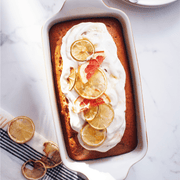 Emile Henry | Modern Classics Loaf Pan showcasing a citrus loaf with icing and fruit slices, highlighting the pan's transition from oven to table for Athens Cooks.