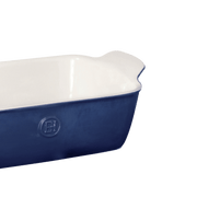 Emile Henry Modern Classics Loaf Pan, Sugar: A rectangular ceramic dish with a glossy white interior and deep blue exterior, ideal for baking and serving.