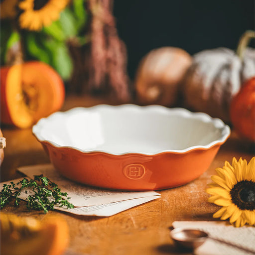Emile Henry | Pumpkin Pie Dish on a wooden table, surrounded by autumnal decor, perfect for even heat baking and stylish oven-to-table presentations.