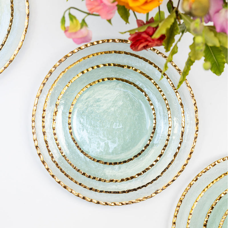 Annie Glass | Edgey Dinner Plate with gold-rim, arranged with Edgey Soup Bowl and Charger. Translucent elegance for versatile dining, showcased on a white surface.