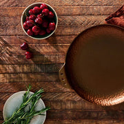 Smithey Farmhouse Skillet showing hammered rim beside cherries and herbs