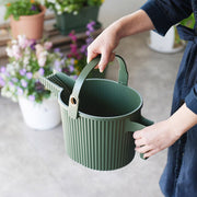 Hand carrying Hachiman Garden Beetle small watering can in Garden Green