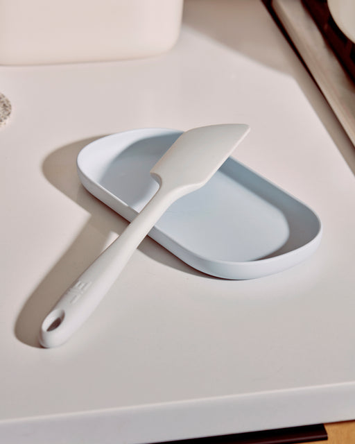 GIR | Ultimate Spatula - Studio White displayed on a tray, highlighting its premium silicone design and versatility for various cooking tasks.