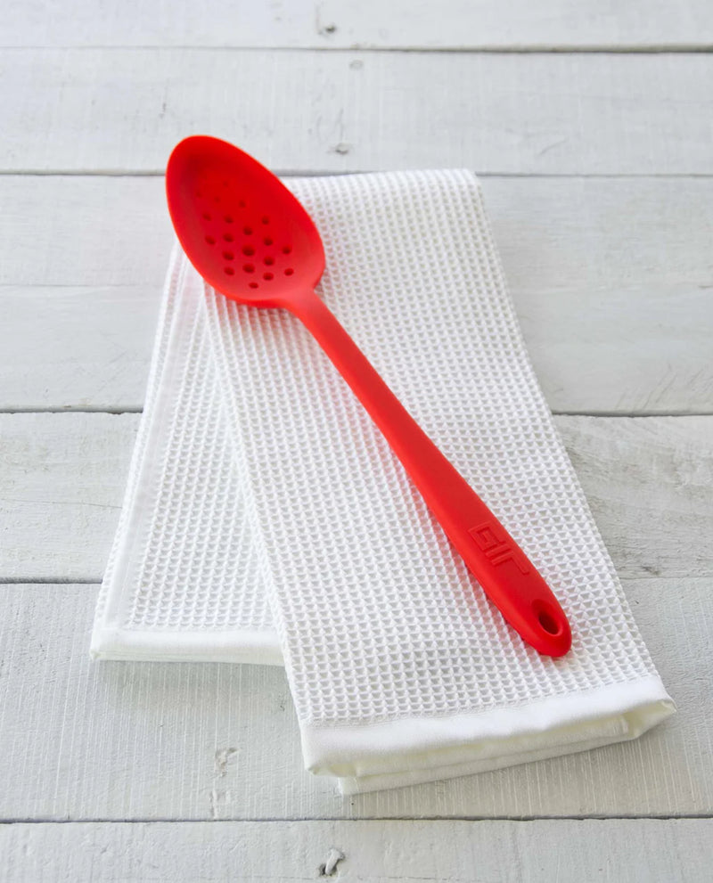 GIR Get It Right - GIR Perforated Spoon: Red, shown on a white towel, features a branching hole pattern for efficient straining and skimming.