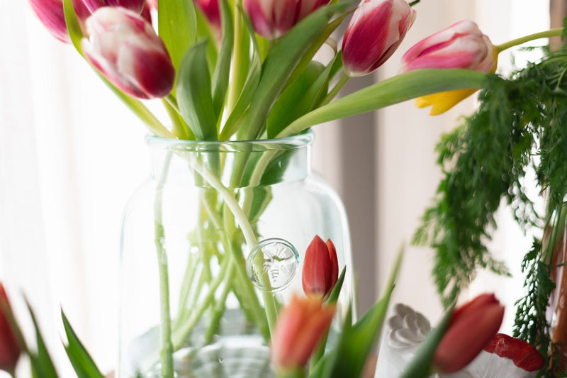 Etú HOME | French Bee Mason Jar Small, elegantly displaying fresh flowers, features a vintage-inspired bee seal and graceful sloping sides, ideal for a sophisticated kitchen aesthetic.