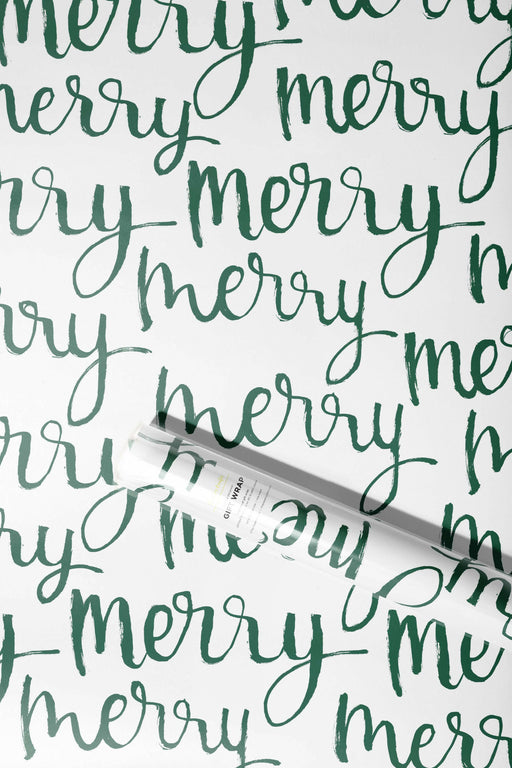 The Paper Curator | Gift Wrap - Merry: A roll of gift wrap featuring elegant green calligraphy on white satin paper, designed for versatile, festive occasions.