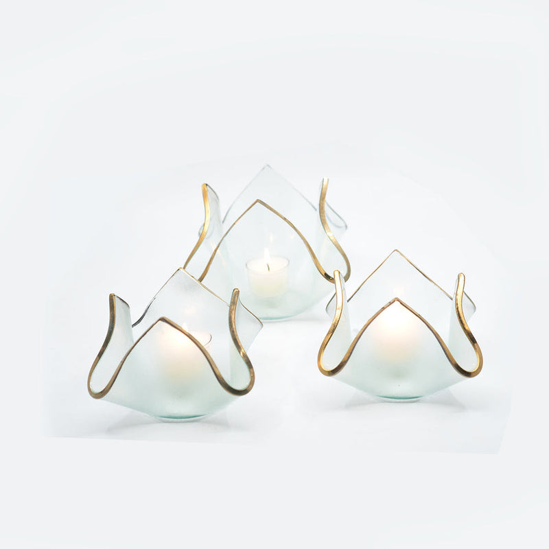 Annie Glass | 7 x 7 x 5 XL Handkerchief Votive, featuring frosted-glass with a gold-trimmed, petal-like shape, beautifully illuminated by lit tealight candles.