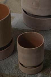 Bergs Potter | Hoff Raw Collection - 5.5 in-14 cm features a close-up of a stackable terracotta pot with a hand-dipped saucer, embodying minimalist Scandinavian design.