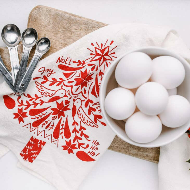 Your Green Kitchen | Holiday Tea Towels - Holiday Houses displayed with a bowl of eggs and spoons on a cutting board, emphasizing kitchen utility and style.