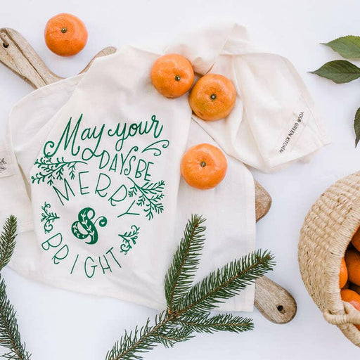 Your Green Kitchen | Holiday Tea Towels displayed with fresh oranges, highlighting their natural, organic cotton fabric perfect for any kitchen setting.