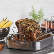 Hestan Provisions | Classic Roaster with Rack, 14.5 Inches, showcasing a herb-crusted roast in a stainless-steel pan, perfect for optimal roasting and serving.