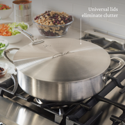 Hestan | Commercial Clad Stainless Steel Universal Lids - 12.5 on sauté pan, with mirepoix prep bowls nearby, showcasing versatile kitchen cookware endorsed by Chef Thomas Keller.