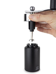 Peugeot | Isen Nutmeg Mill, Matte Black, showcasing its metal adjustment knob, spindle with grinding blade, and cylindrical container, ideal for finely grinding nutmeg.