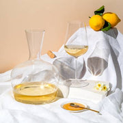 Richard Brendon | Jancis Robinson Original Wine Glass Set of 2 alongside a wine bottle and lemons, showcasing its elegant design for enhancing wine tasting.