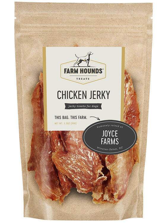 Farm Hounds | Jerky Treats - Turkey Jerky package on a table, next to a black and white dog, showcasing natural, pasture-raised poultry treats.