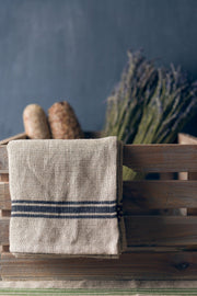 Thieffry | Monogramme Napkin Set of 4 displayed in a wicker basket with lavender, highlighting their elegant linen texture and timeless appeal.
