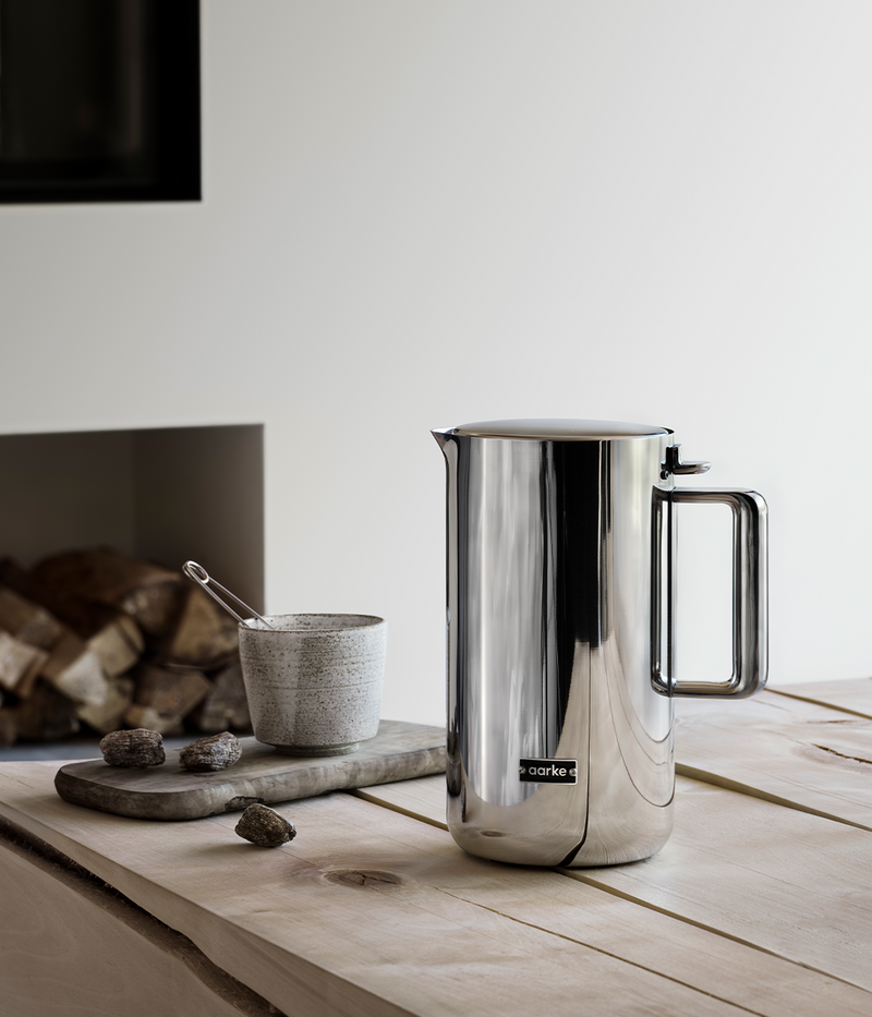 Aarke | Stainless Steel Kettle on wooden surface, showcasing its sleek, modern design and durable stainless steel construction, ideal for sustainable water heating.