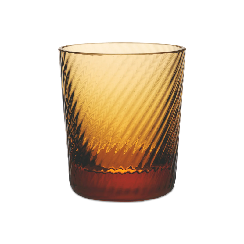 Match | Lando Shot Glass, Amber, Twist: A cylindrical amber-tinted tumbler with a diagonal wave-like texture, creating a swirling light-and-shadow effect.