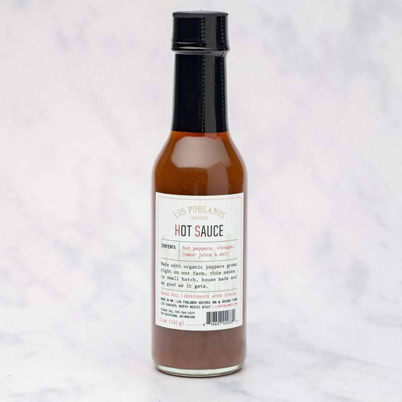 Los Poblanos | Hot Sauce: 5 oz bottle of small-batch, farm-made hot sauce with organic peppers. Ideal for enhancing meals with just-right heat and zesty tang.
