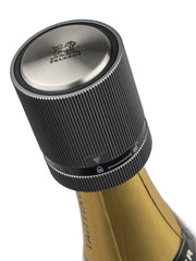 Peugeot | Line Sparkling Wine Stopper on a Taittinger bottle, featuring a ribbed, screw-top design with Peugeot's lion logo, preserving wine's freshness and sparkle.