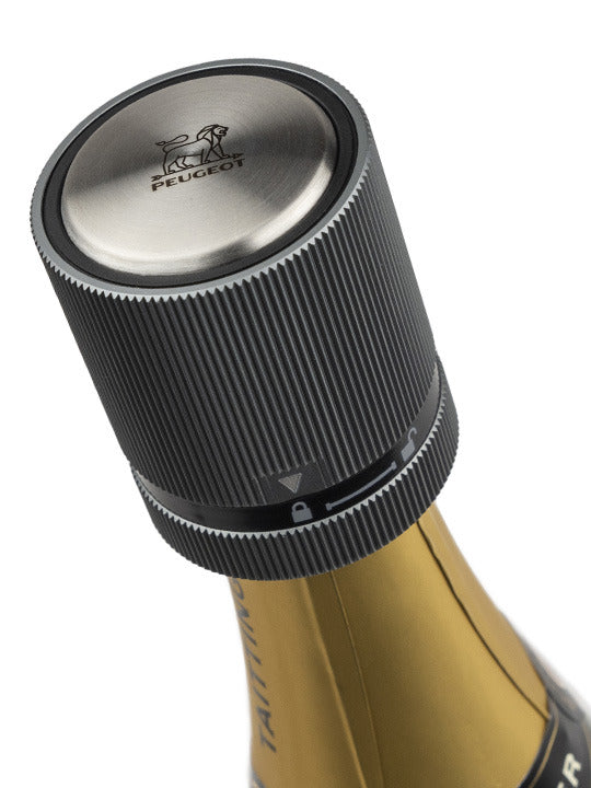 Peugeot | Line Sparkling Wine Stopper on a Taittinger bottle, featuring a ribbed, screw-top design with Peugeot's lion logo, preserving wine's freshness and sparkle.