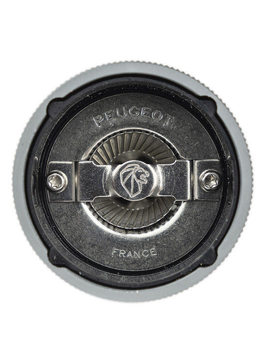 Close-up of the Peugeot | Line Salt Mill Aluminum + Beechwood, Carbon, highlighting the steel burr mechanism, embossed with “Peugeot” and “France,” showcasing precision grind adjustment.