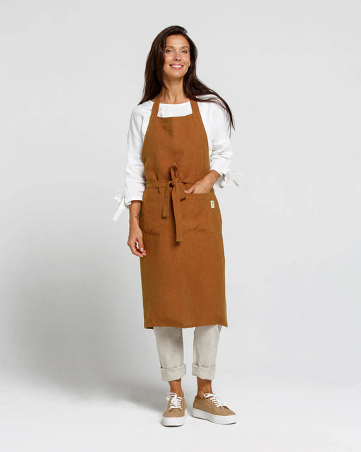 MagicLinen's Linen Bib Apron in Forest Green, showcasing its durable linen fabric, unisex fit, and elegant design, ideal for kitchen and garden enthusiasts.