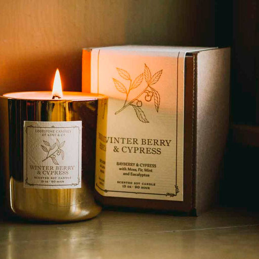 Lodestone's Luxury Soy Candle - Winterberry & Cypress, featuring a label with a branch drawing, offers a sophisticated, eco-friendly aroma with a clean, lasting burn.